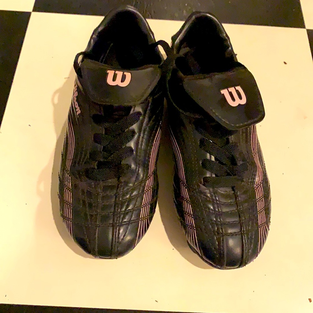 Black soccer shoes with subtle pink trim